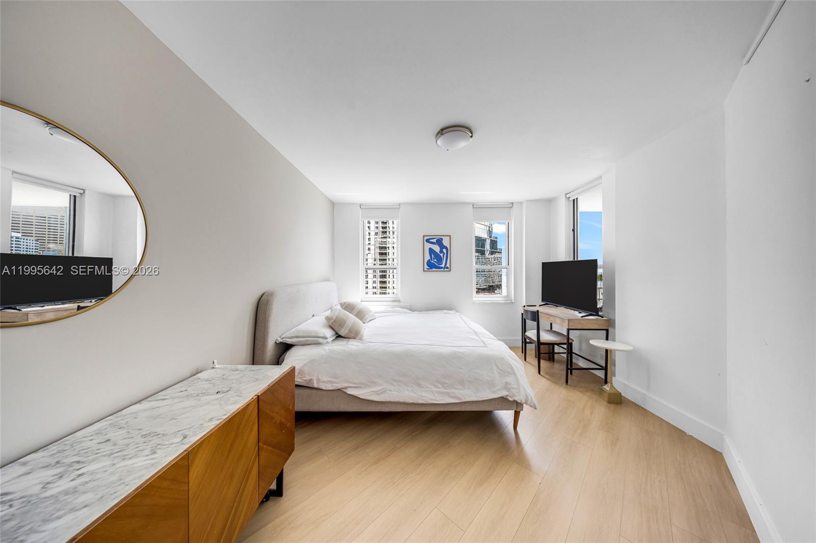 701 Brickell Key Boulevard, Unit 1112 Miami, FL 33131 - Photo 13 of 31 a bedroom with a bed and a chair