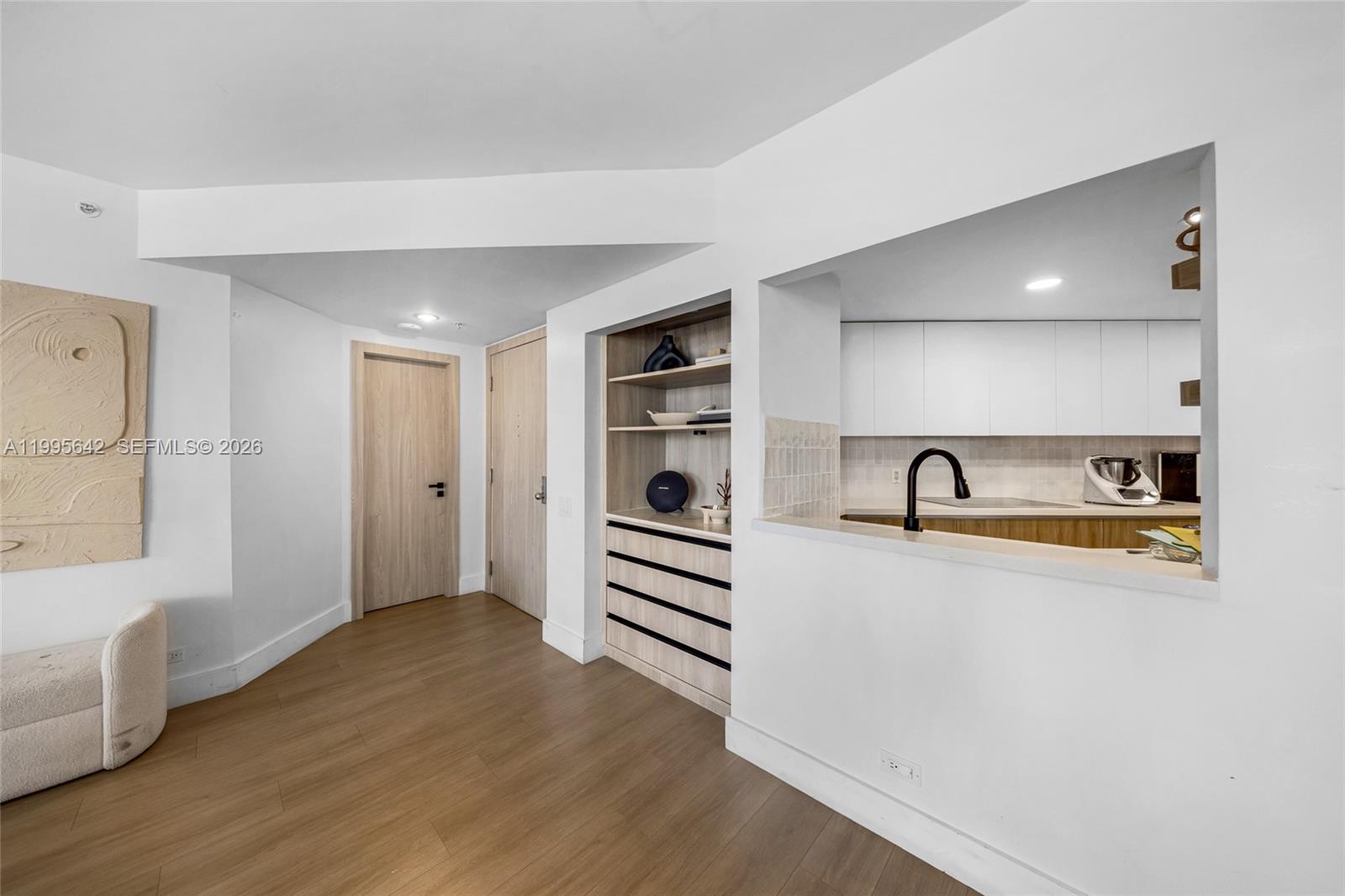 701 Brickell Key Boulevard, Unit 1112 Miami, FL 33131 - Photo 18 of 31 a view of a storage & utility room with wooden floor