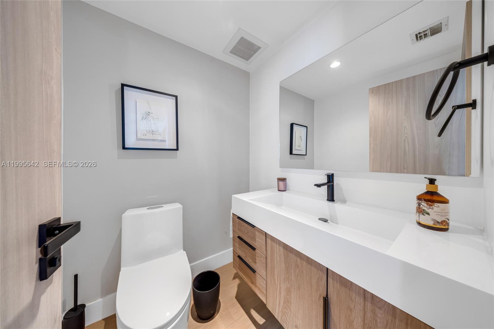 701 Brickell Key Boulevard, Unit 1112 Miami, FL 33131 - Photo 19 of 31 a bathroom with a sink mirror and toilet