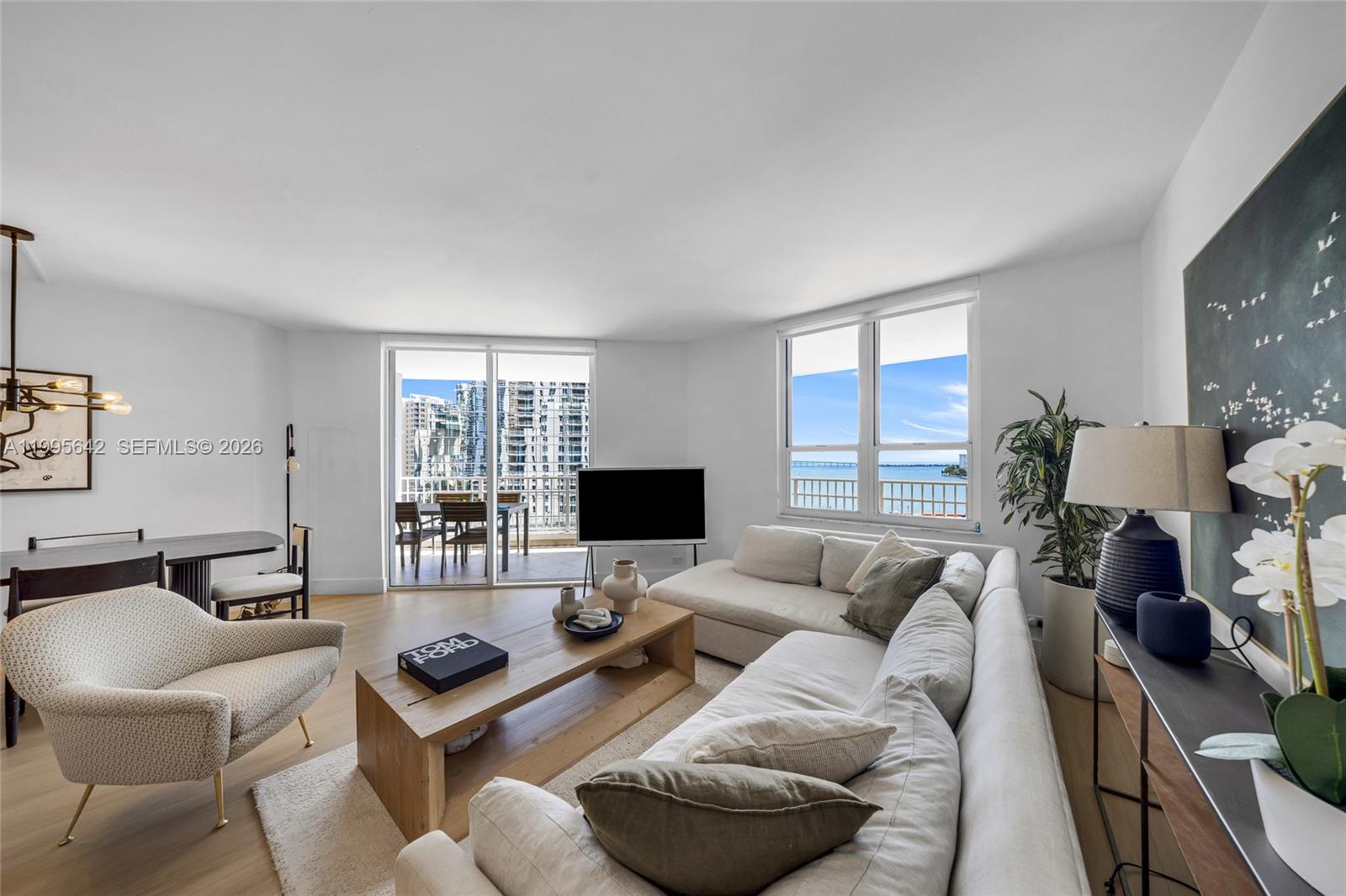 701 Brickell Key Boulevard, Unit 1112 Miami, FL 33131 - Photo 2 of 31 a living room with furniture fireplace and a large window