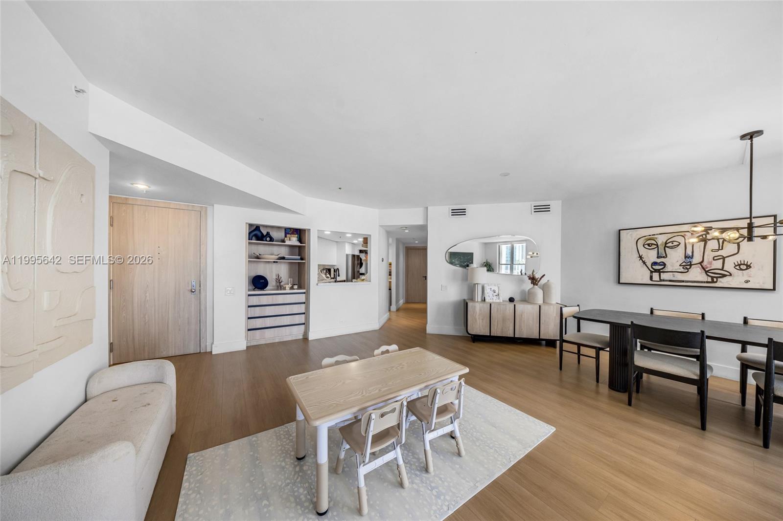 701 Brickell Key Boulevard, Unit 1112 Miami, FL 33131 - Photo 21 of 31 a living room with furniture a rug and a wall painting