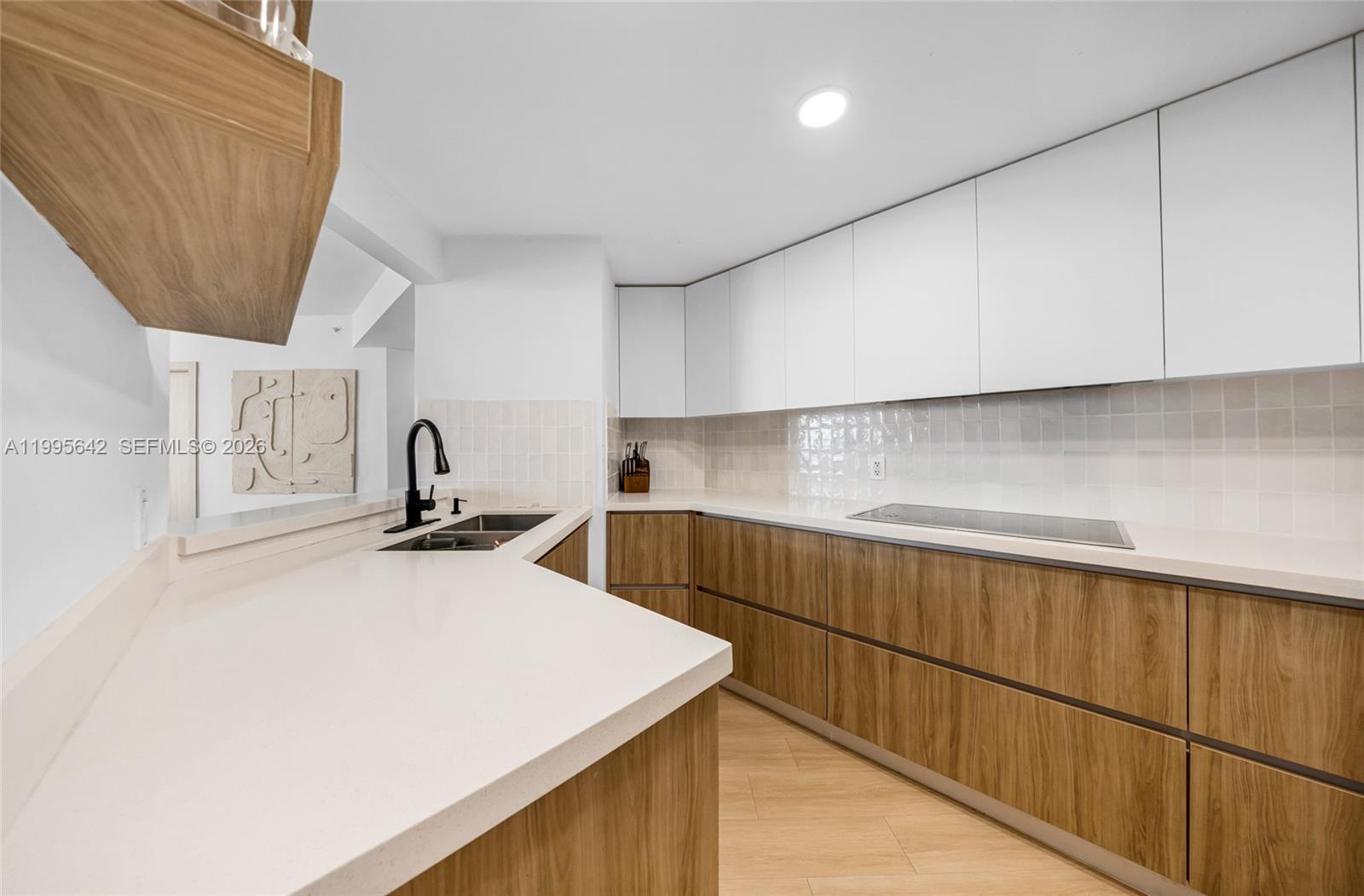 701 Brickell Key Boulevard, Unit 1112 Miami, FL 33131 - Photo 3 of 31 a kitchen with a sink a stove and cabinets
