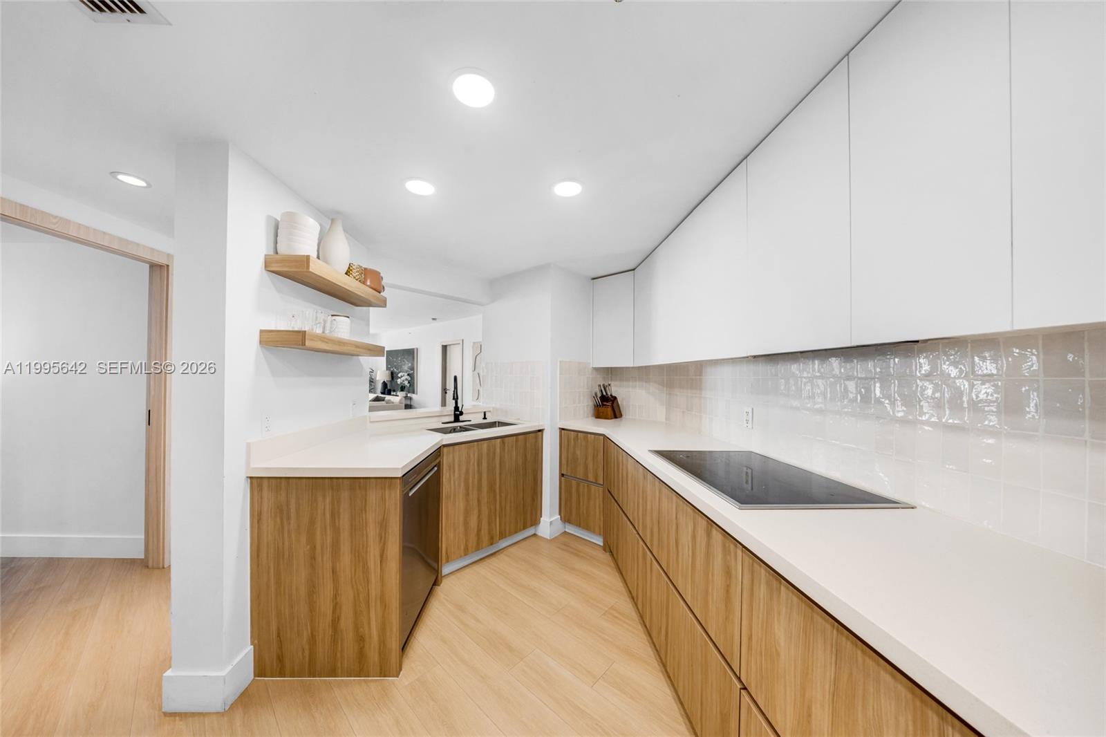 701 Brickell Key Boulevard, Unit 1112 Miami, FL 33131 - Photo 5 of 31 a kitchen with granite countertop a sink and cabinets