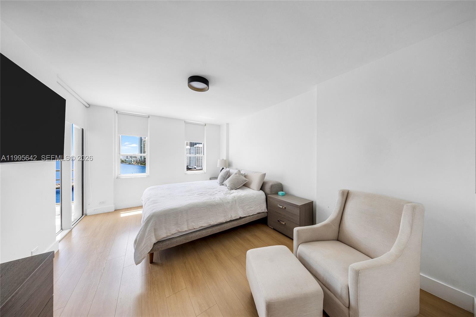 701 Brickell Key Boulevard, Unit 1112 Miami, FL 33131 - Photo 7 of 31 a bedroom with bed and a flat screen tv