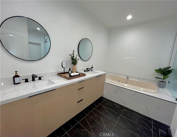 a bathroom with a double vanity sink and a mirror