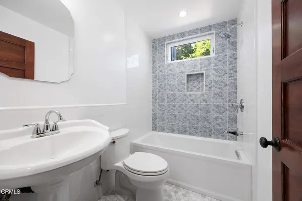 a bathroom with a sink a toilet and a bathtub