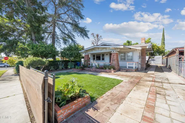 a view of a house with backyard sitting area and garden