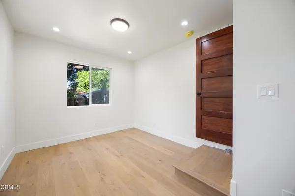 an empty room with windows and closet