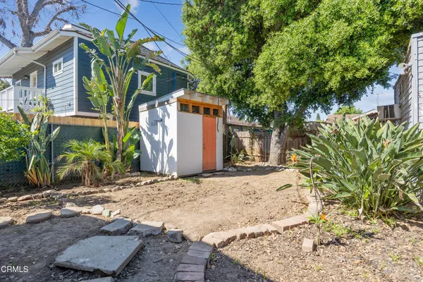 a view of a house with a yard and plant
