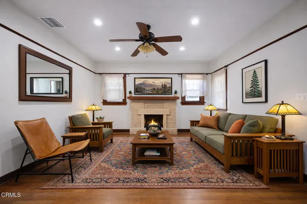 a living room with furniture a rug and a fireplace