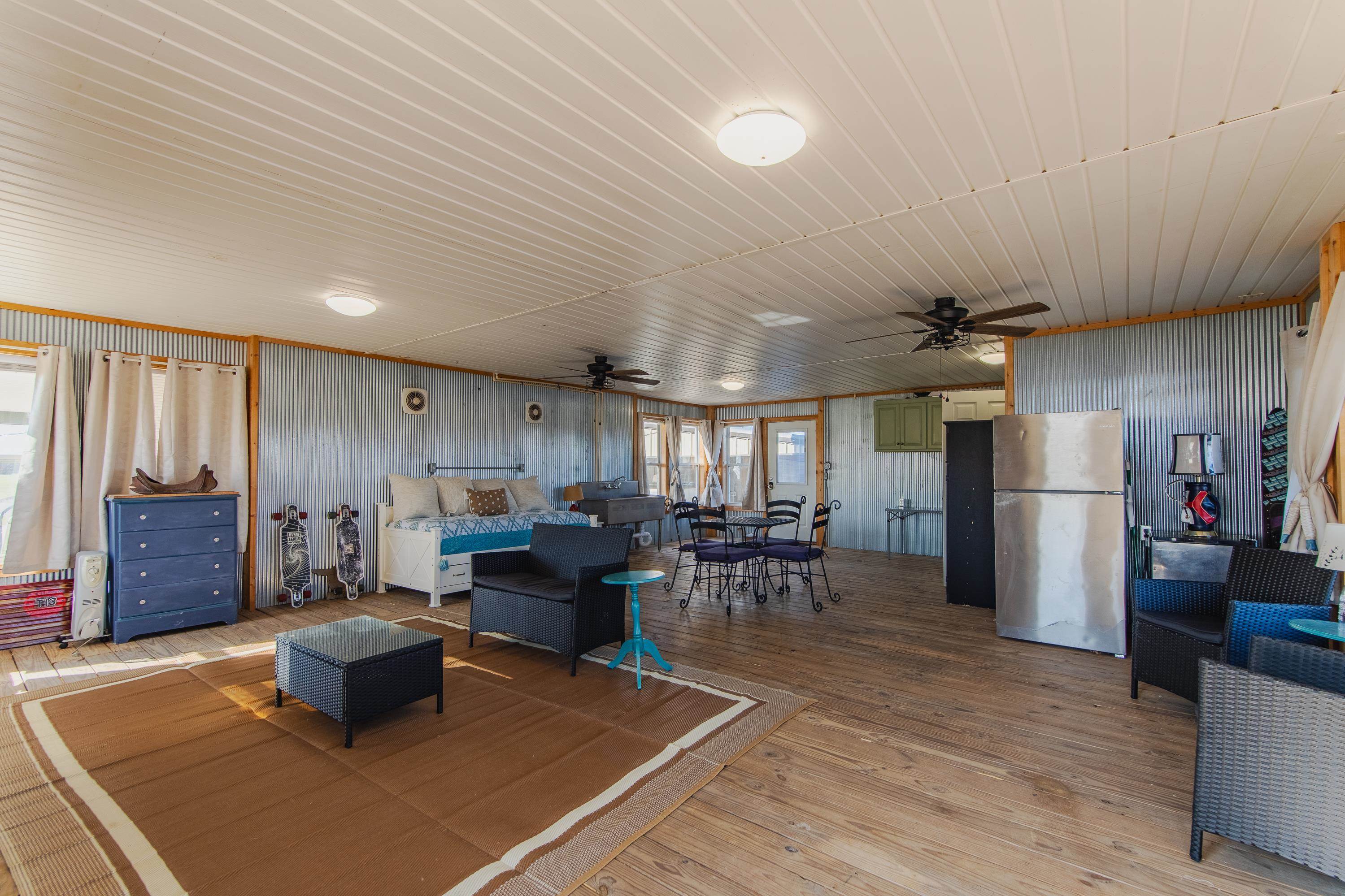 1111 Leaning Trees Lane Adamsville, TN 38310 - Photo 15 of 25 a living room with furniture a dining table and chairs with wooden floor