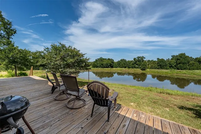 a view of a lake with deck and outdoor seating