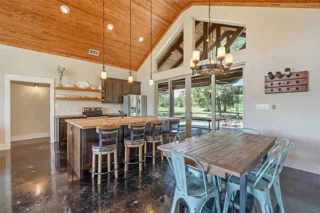 a dining room with furniture a rug and a chandelier