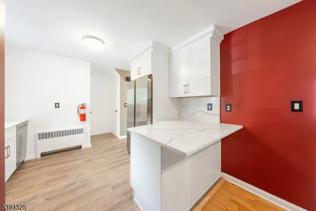 a room with a sink and a refrigerator