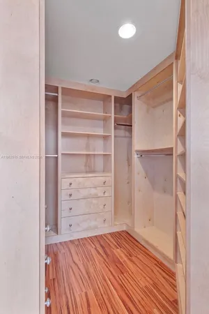 a view of walk in closet with empty racks