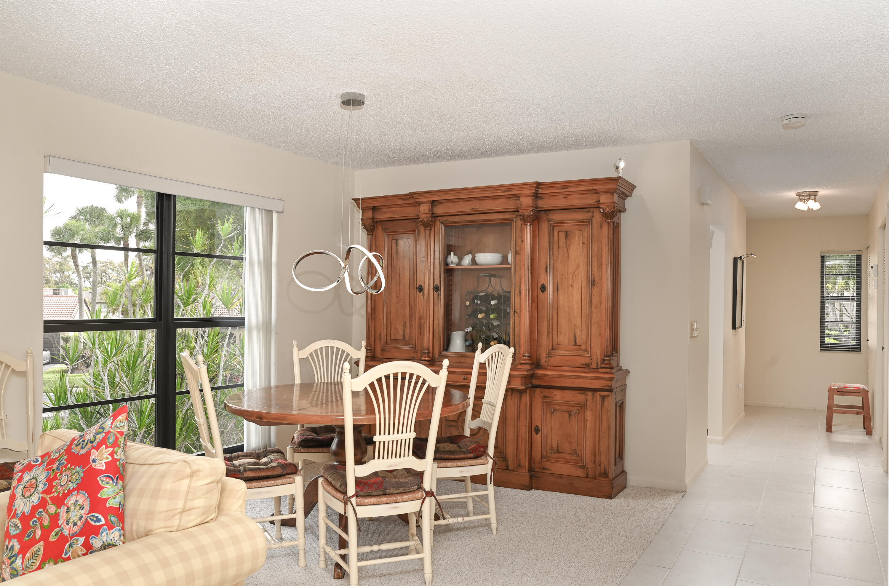 9259 Vista Del Lago, Unit 18J Boca Raton, FL 33428 - Photo 11 of 37 a dining room with furniture and window