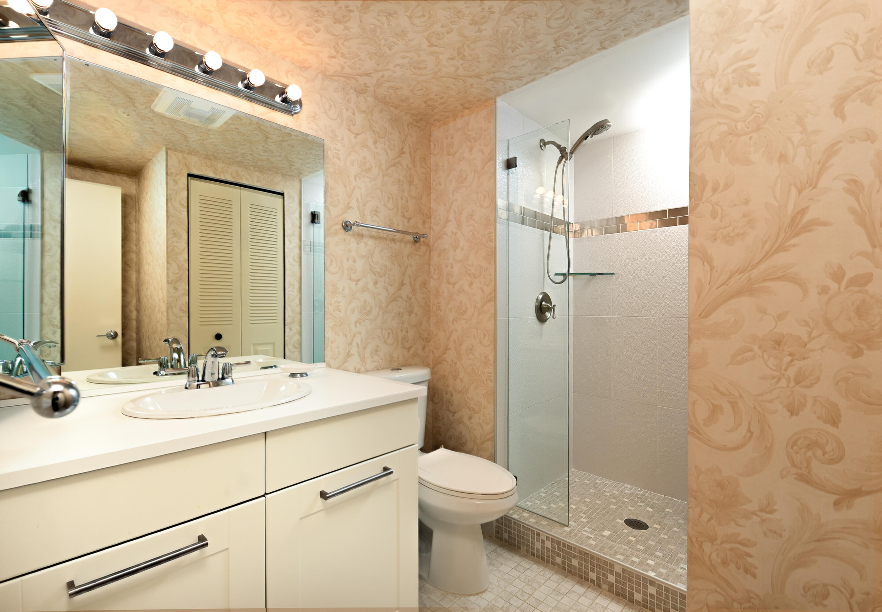 9259 Vista Del Lago, Unit 18J Boca Raton, FL 33428 - Photo 23 of 37 a bathroom with a sink a toilet and shower