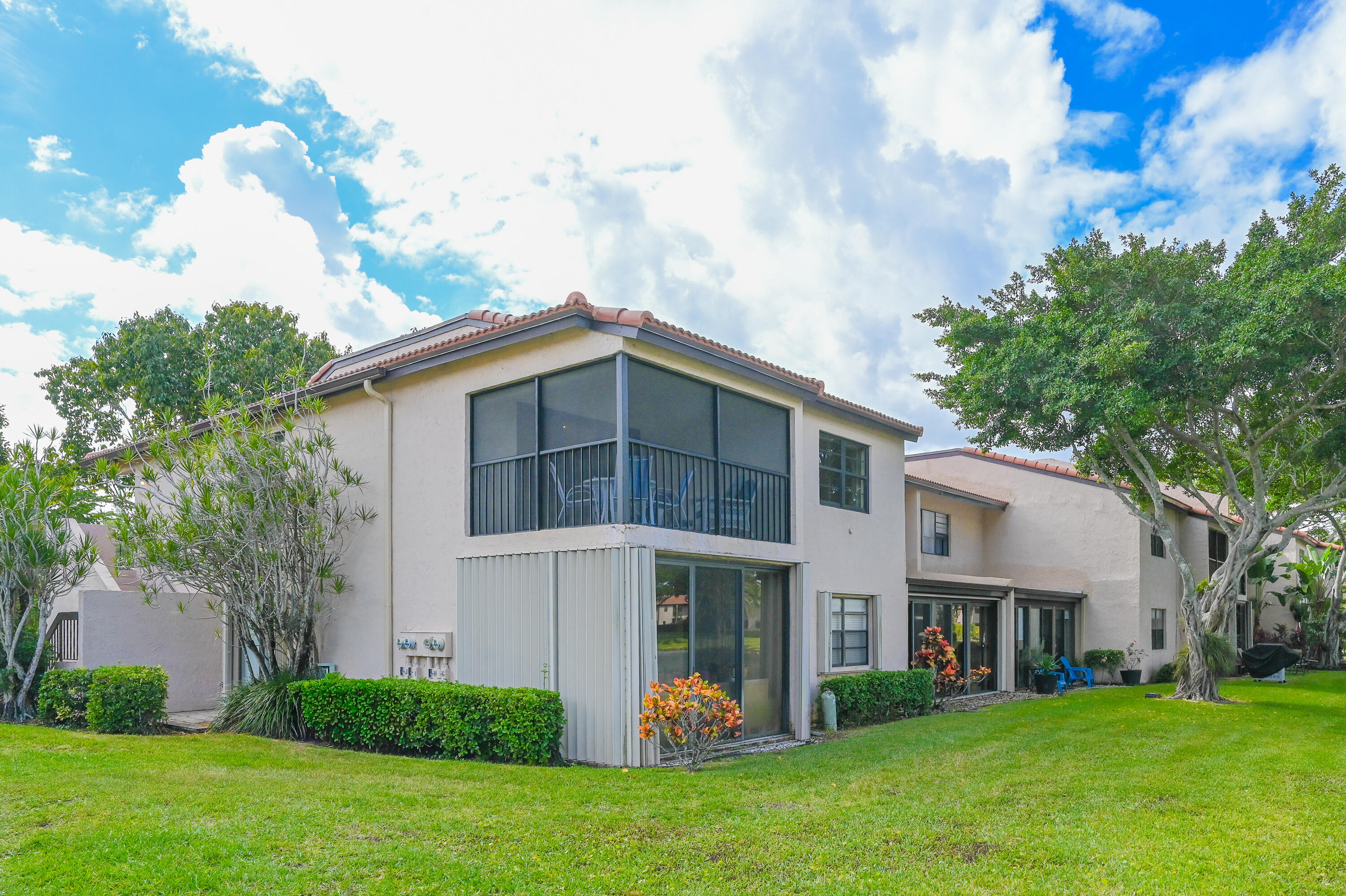 9259 Vista Del Lago, Unit 18J Boca Raton, FL 33428 - Photo 26 of 37 a front view of a house with a garden