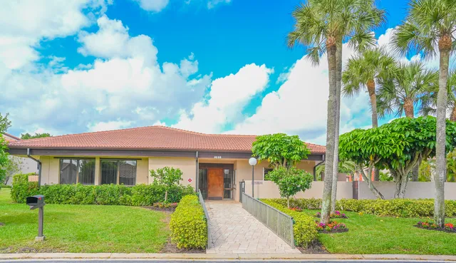 a front view of a house with a yard table and chairs