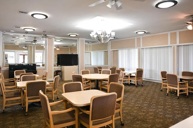 a front view of a house with a garden and plants