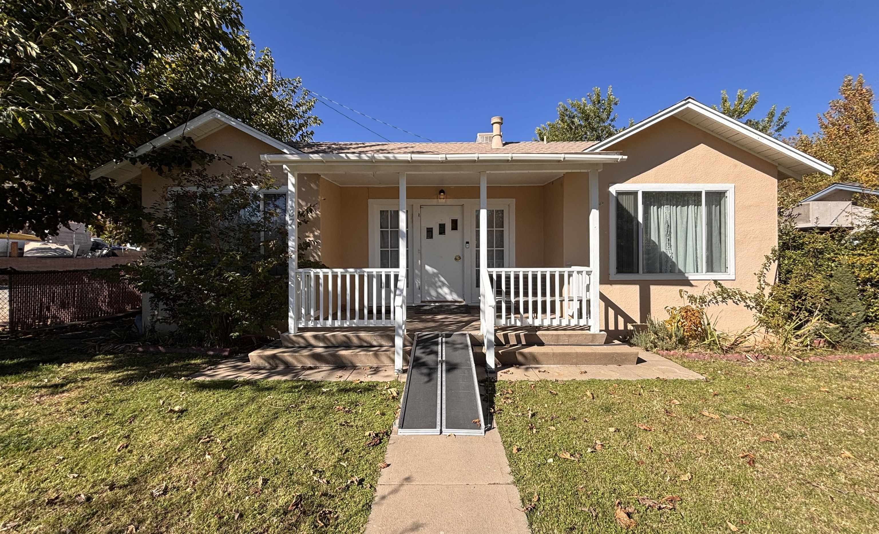 137 East Payne Street, Unit 5 Independence, CA 93526 - Photo 1 of 11 a front view of a house with a yard