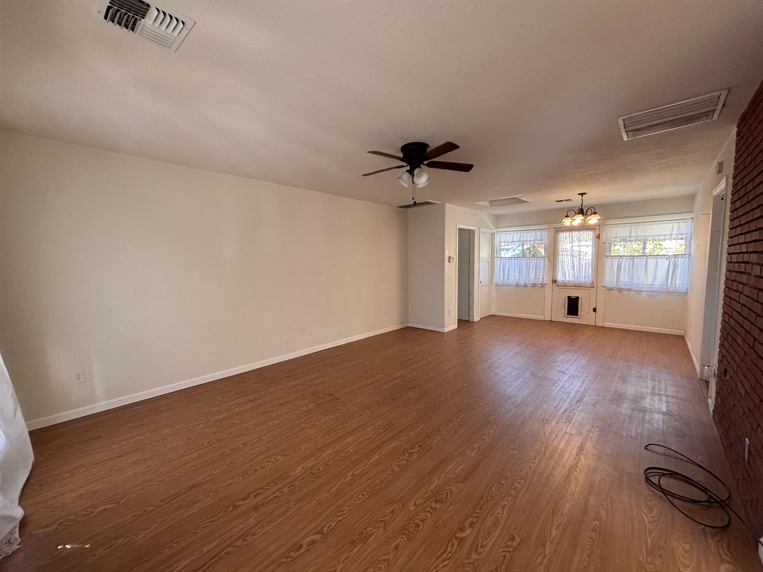 137 East Payne Street, Unit 5 Independence, CA 93526 - Photo 2 of 11 a view of a big room with wooden floor and windows