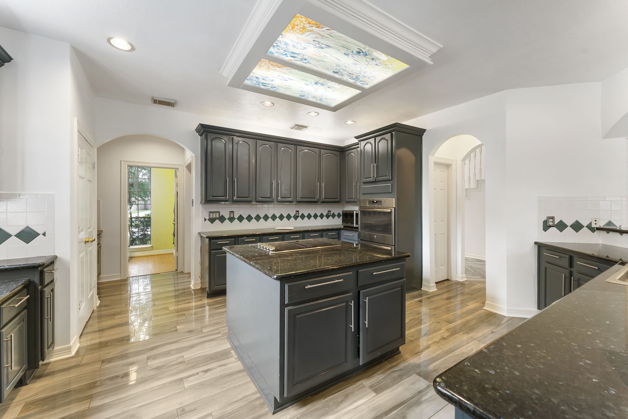 12907 Ryaneagles Circle Houston, TX 77044 - Photo 19 of 48 a kitchen with granite countertop a stove cabinets and refrigerator