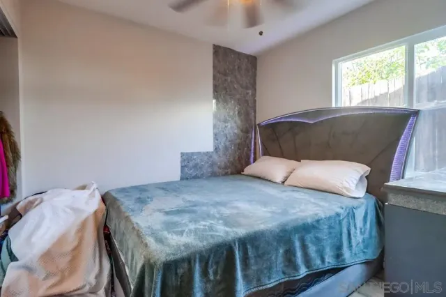 a bedroom with a bed and window