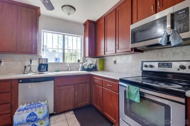 a kitchen with a sink stove and cabinets