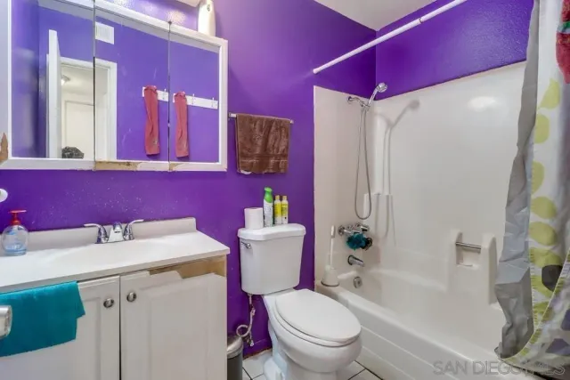 a bathroom with a sink vanity mirror and toilet