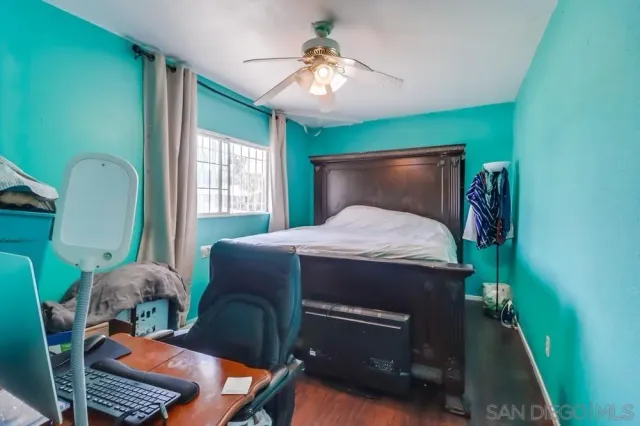 a bedroom with a bed window and a chandelier