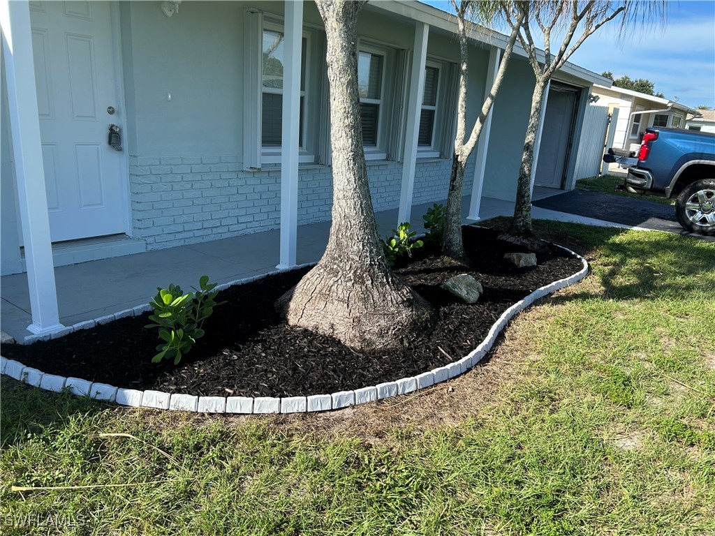 18194 Iris Road Fort Myers, FL 33967 - Photo 2 of 33 a view of a house with a yard and sitting area