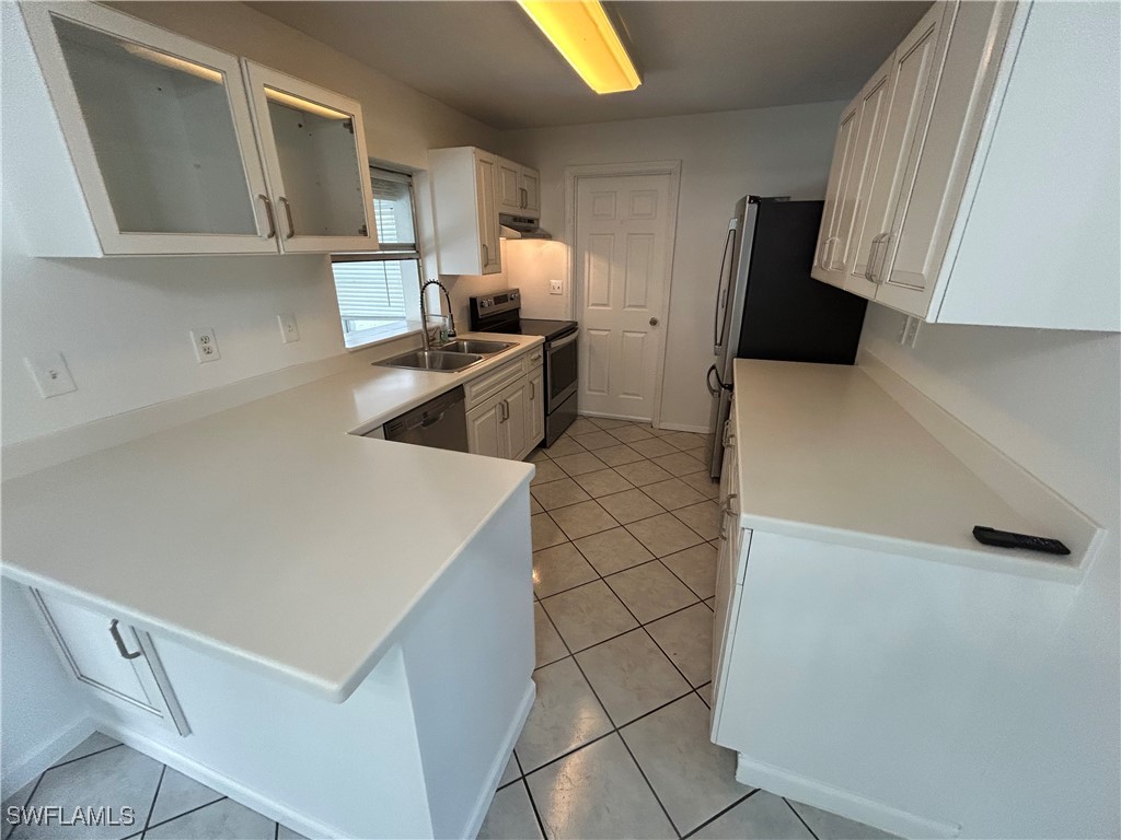 18194 Iris Road Fort Myers, FL 33967 - Photo 3 of 33 a kitchen with stainless steel appliances a refrigerator and a sink