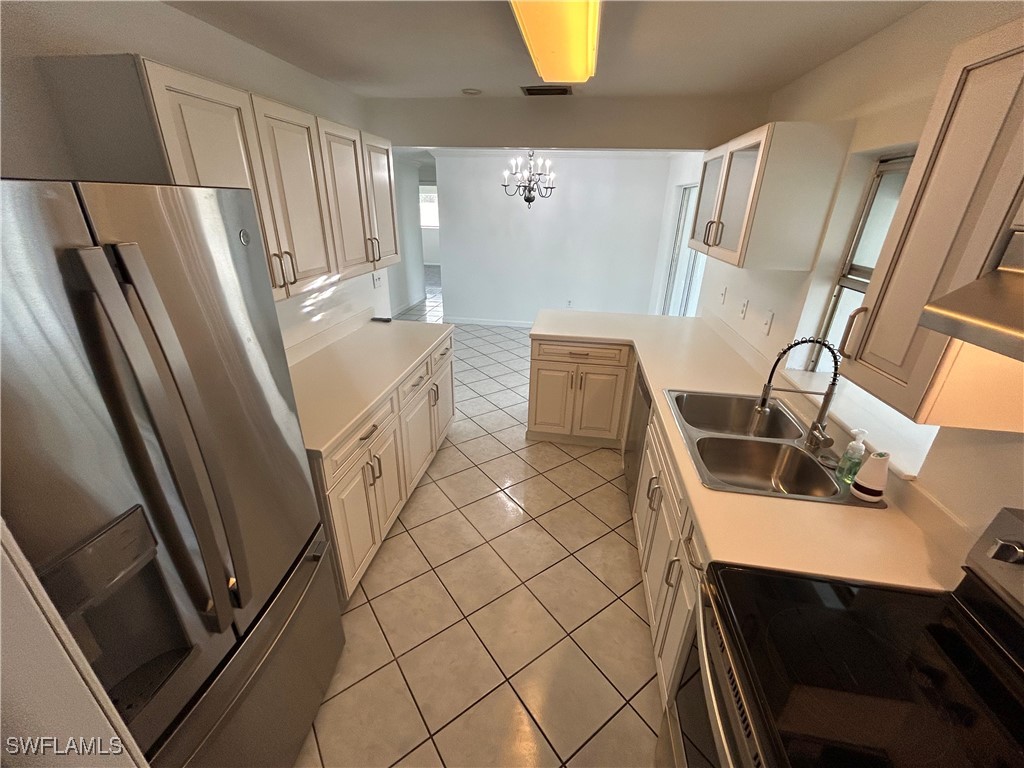18194 Iris Road Fort Myers, FL 33967 - Photo 4 of 33 a kitchen with a sink a refrigerator and washer