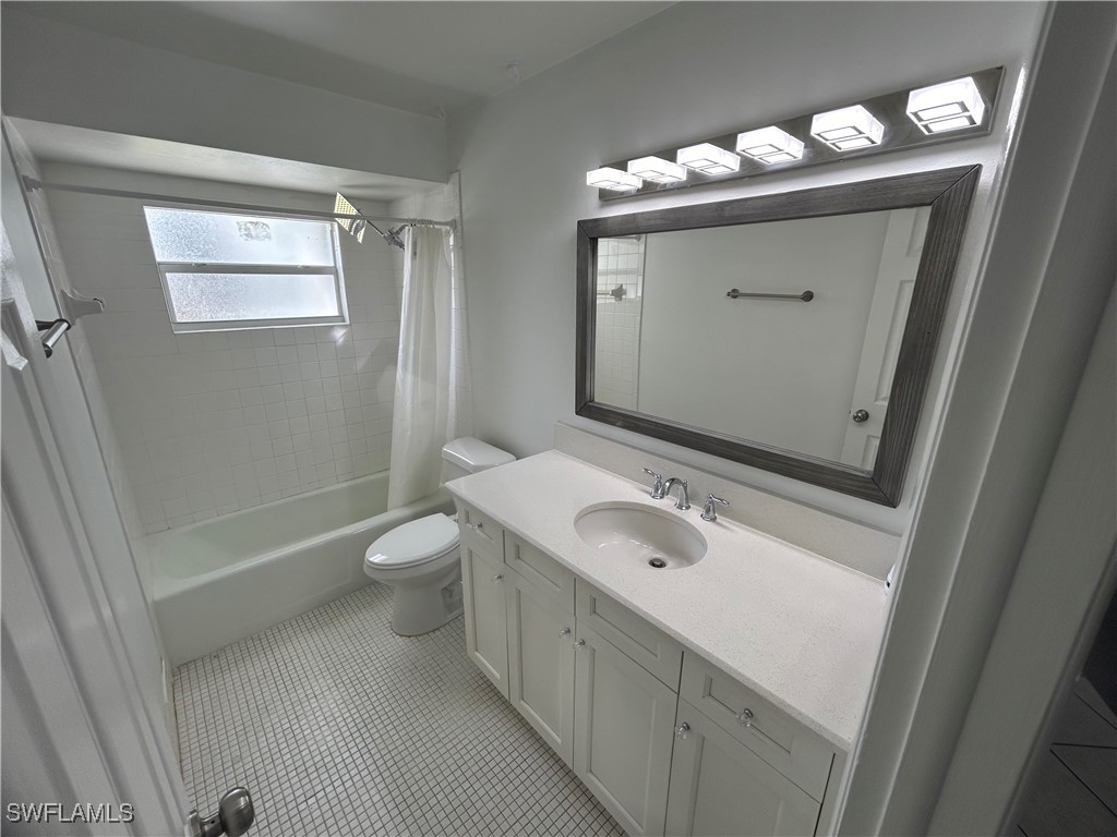 18194 Iris Road Fort Myers, FL 33967 - Photo 8 of 33 a bathroom with a sink a toilet a mirror and shower