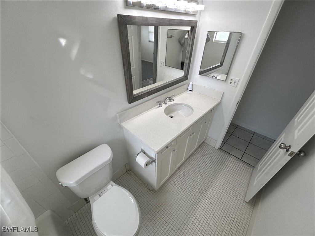 18194 Iris Road Fort Myers, FL 33967 - Photo 9 of 33 a bathroom with a toilet sink and mirror