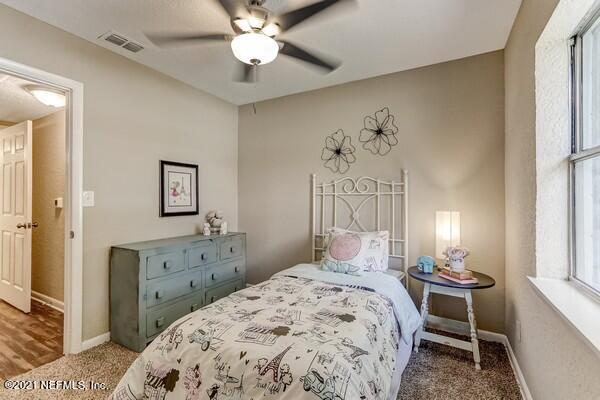 100 Lighthouse Road South Jacksonville, FL 32225 - Photo 25 of 33 a bedroom with a bed and a chandelier