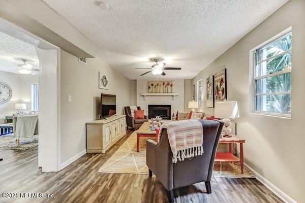 100 Lighthouse Road South Jacksonville, FL 32225 - Photo 6 of 33 a living room with furniture a fireplace and a flat screen tv