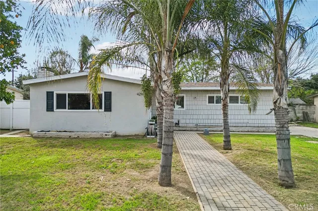 a view of a house with swimming pool and sitting area