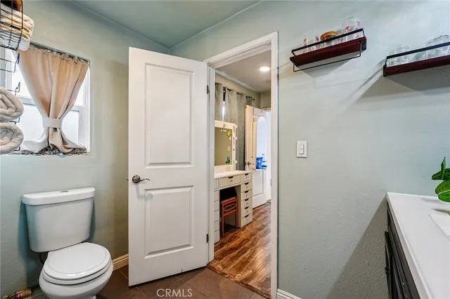 a view of a hallway with furniture and windows