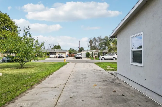 a view of yard with green space and trees in the background