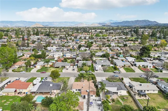 an aerial view of a house with a yard