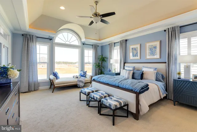 a spacious bedroom with a bed and a chandelier