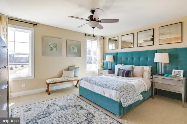 a bedroom with a large bed and a chandelier