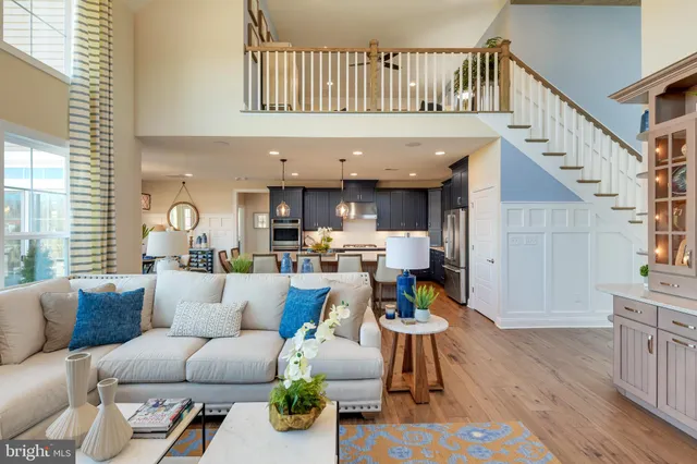 a living room with furniture and a dining table