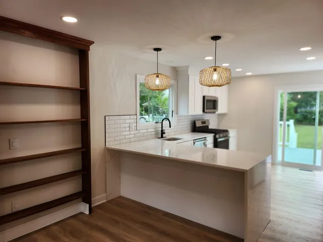 a kitchen with chandelier and sink