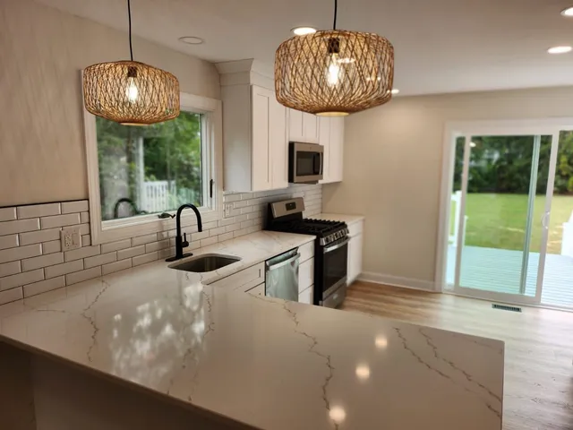 a kitchen with appliances a sink and a window