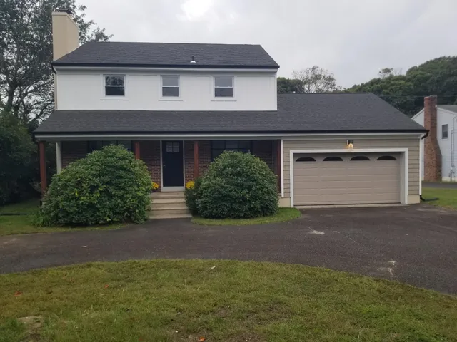 a front view of a house with yard and garage