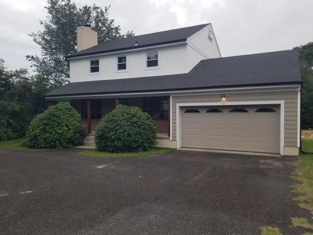 a front view of a house with garage