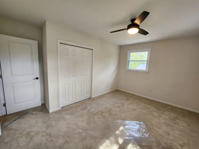 a view of a house with backyard and deck